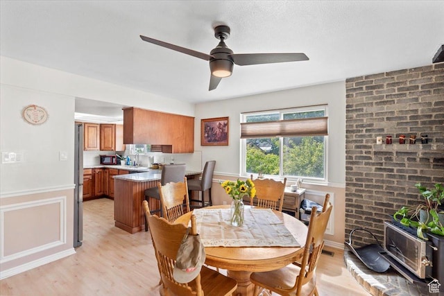 dining room featuring light wood finished floors and ceiling fan
