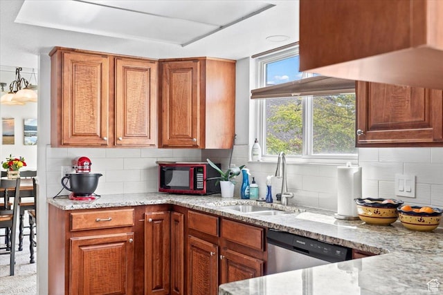 kitchen with dishwasher, a sink, light stone counters, tasteful backsplash, and brown cabinets