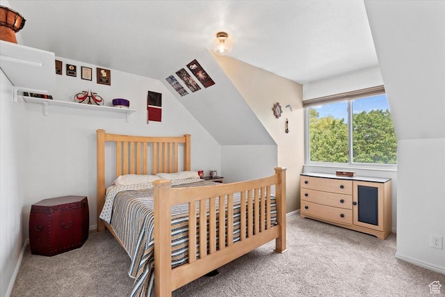 bedroom with carpet, vaulted ceiling, and baseboards