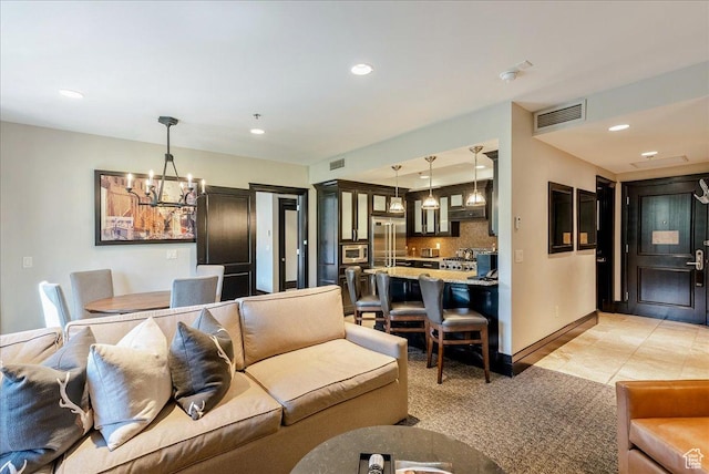 living area with a chandelier, recessed lighting, baseboards, and light tile patterned floors