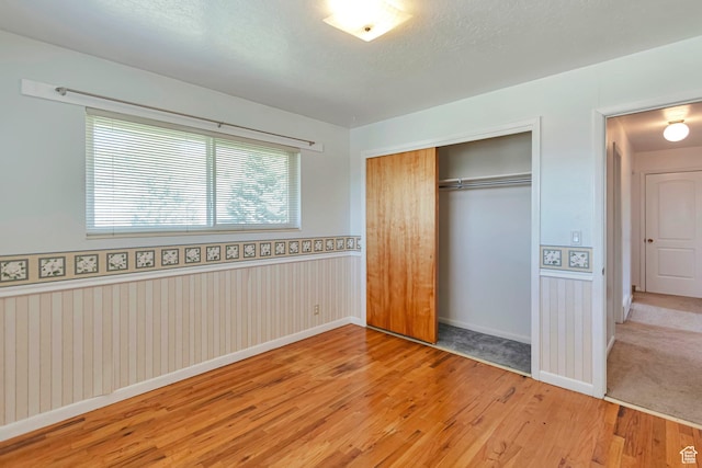 274 N 400 E, Hyde Park, UT 84318 - unfurnished bedroom with wood finished floors, a closet, wainscoting, and baseboards