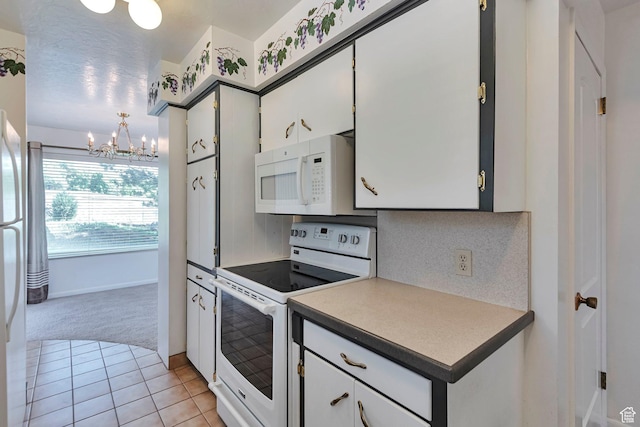 274 N 400 E, Hyde Park, UT 84318 - kitchen featuring white appliances, light carpet, a chandelier, decorative backsplash, and light tile patterned flooring