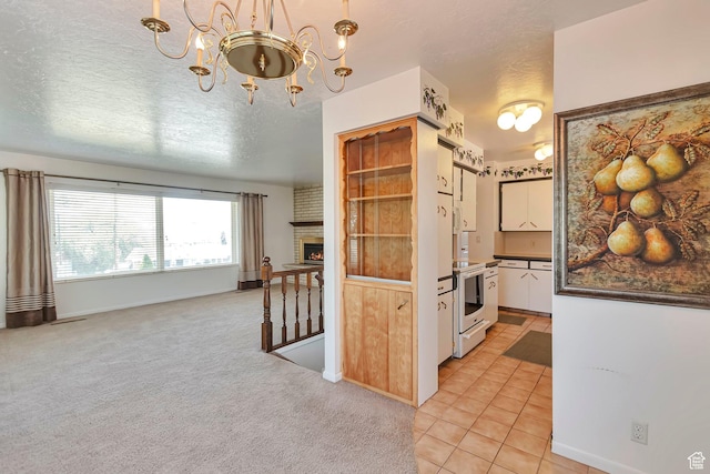 274 N 400 E, Hyde Park, UT 84318 - kitchen featuring a chandelier, dark countertops, white cabinetry, a textured ceiling, and electric range