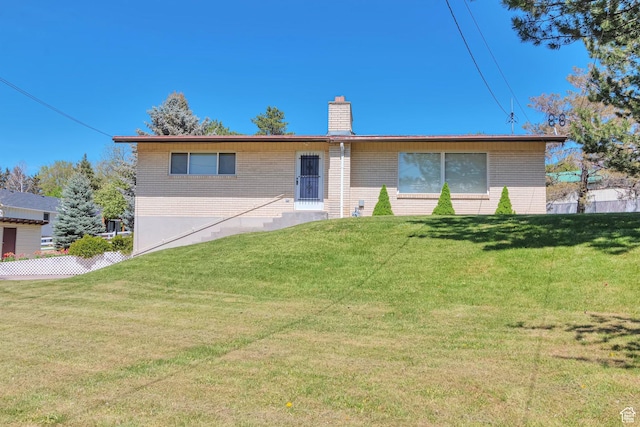 274 N 400 E, Hyde Park, UT 84318 - rear view of property with brick siding, a chimney, and a lawn