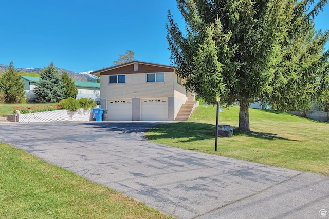 274 N 400 E, Hyde Park, UT 84318 - view of front of property featuring asphalt driveway, an attached garage, a front yard, and stairway