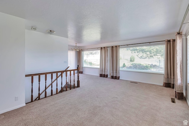 274 N 400 E, Hyde Park, UT 84318 - spare room featuring a chandelier, baseboards, and carpet flooring