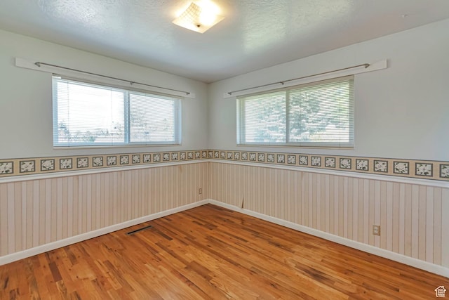 274 N 400 E, Hyde Park, UT 84318 - spare room featuring wood finished floors, a wainscoted wall, baseboards, and a textured ceiling