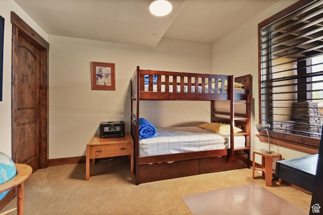 carpeted bedroom with baseboards