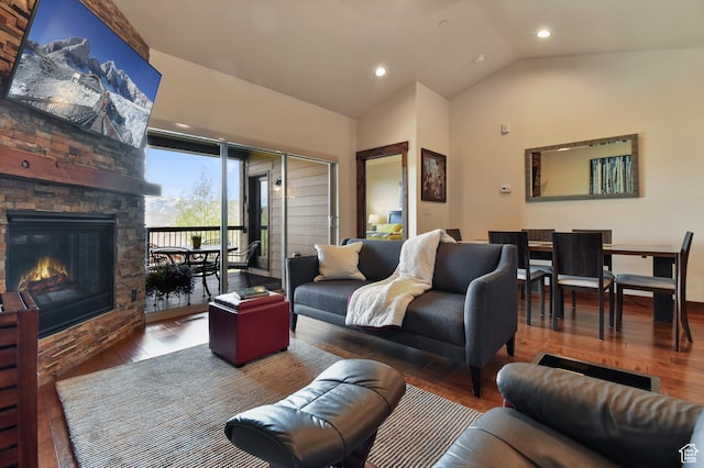 living room with wood finished floors, vaulted ceiling, recessed lighting, and a fireplace