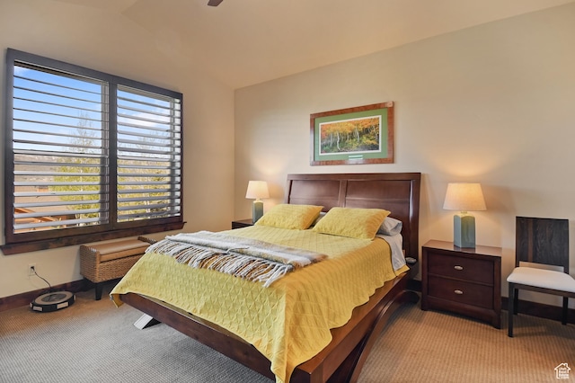 bedroom featuring light colored carpet, baseboards, and lofted ceiling