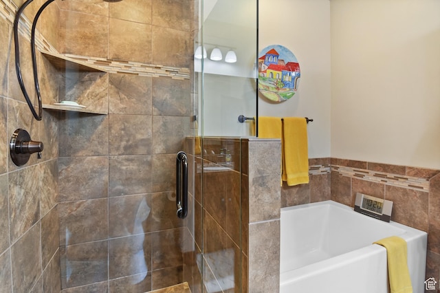 full bathroom featuring a garden tub and a stall shower