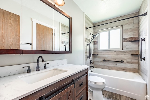 full bathroom with wood finished floors, shower / bath combination, toilet, and vanity