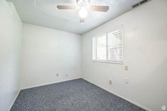 empty room featuring baseboards, carpet flooring, a textured ceiling, and ceiling fan