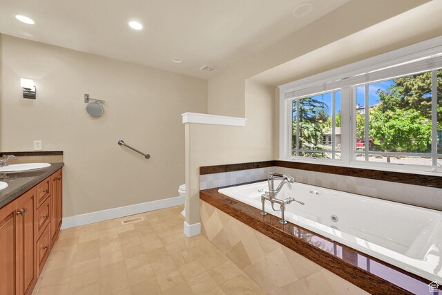 1274 E Chandler, Salt Lake City, UT 84103 - bathroom with plenty of natural light, a tub with jets, baseboards, double vanity, and recessed lighting