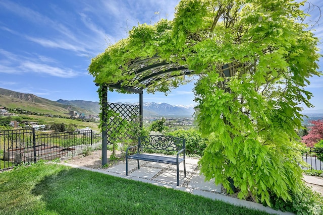 1274 E Chandler, Salt Lake City, UT 84103 - view of home's community with fence, a mountain view, and a patio area