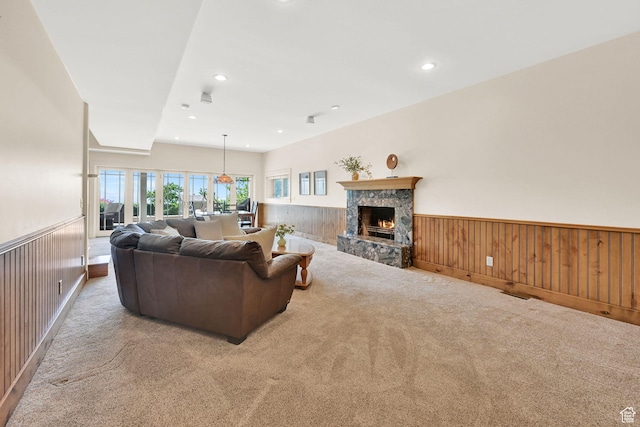 1274 E Chandler, Salt Lake City, UT 84103 - living room featuring wainscoting, carpet floors, a stone fireplace, recessed lighting, and wooden walls