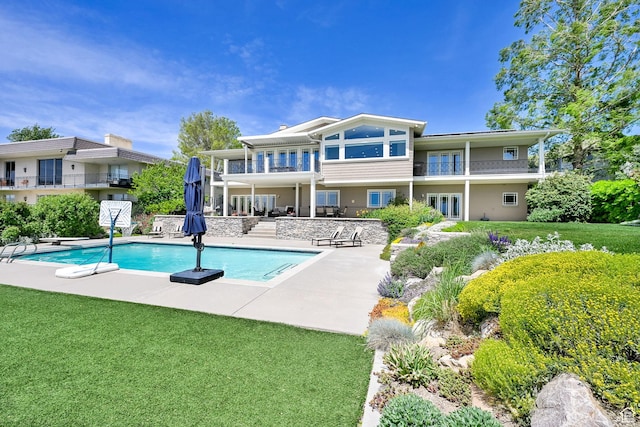 1274 E Chandler, Salt Lake City, UT 84103 - rear view of property featuring a patio, a balcony, an outdoor pool, and a lawn