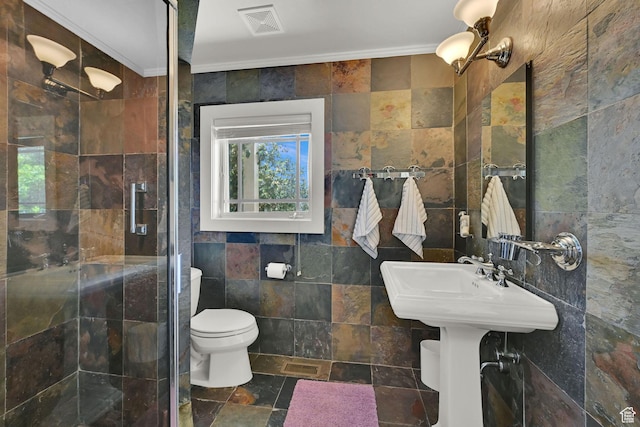 1274 E Chandler, Salt Lake City, UT 84103 - bathroom featuring tile walls, ornamental molding, a stall shower, toilet, and stone finish flooring