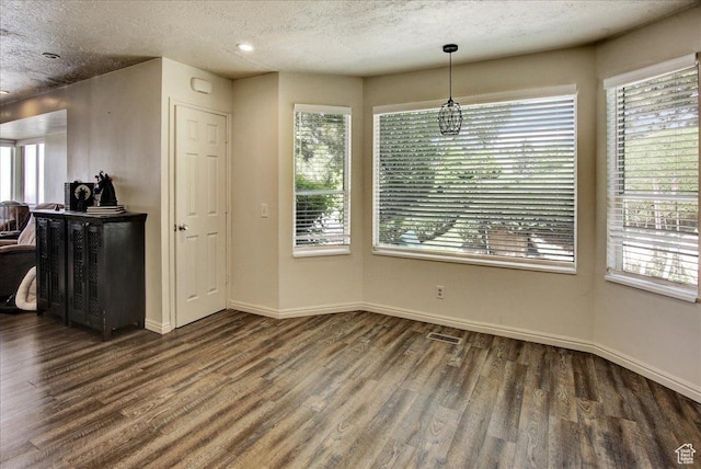 5812 Club View Ln, South Ogden, UT 84405 - unfurnished dining area featuring wood finished floors, baseboards, plenty of natural light, and a textured ceiling