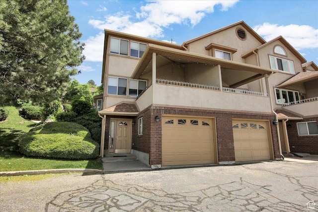 5812 Club View Ln, South Ogden, UT 84405 - view of property with a garage, stucco siding, brick siding, and a balcony