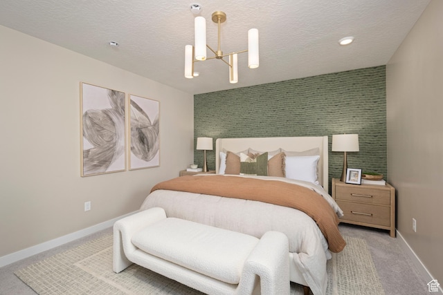 bedroom with carpet, baseboards, a chandelier, and a textured ceiling