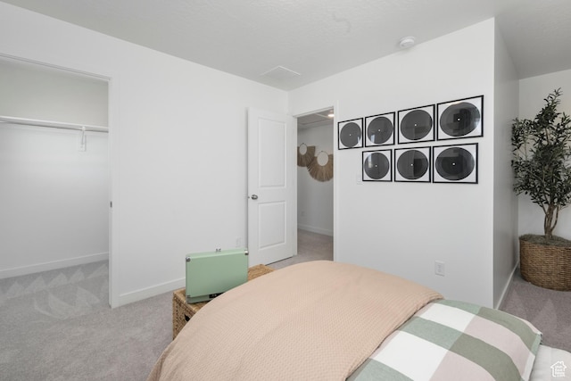 bedroom with carpet, baseboards, and a closet