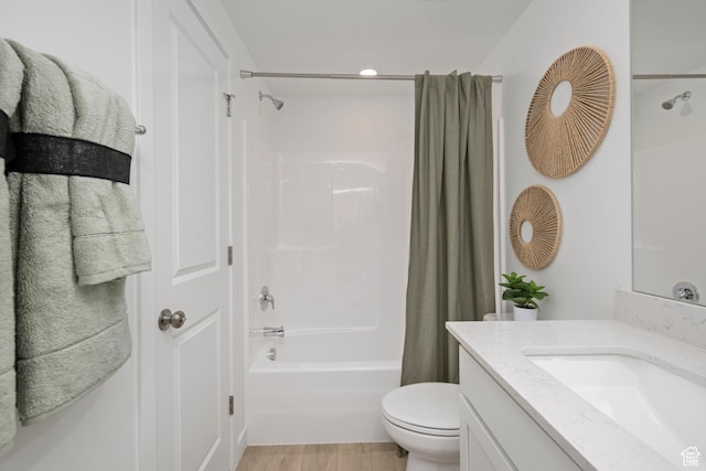 bathroom with shower / bath combo, toilet, vanity, wood finished floors, and recessed lighting