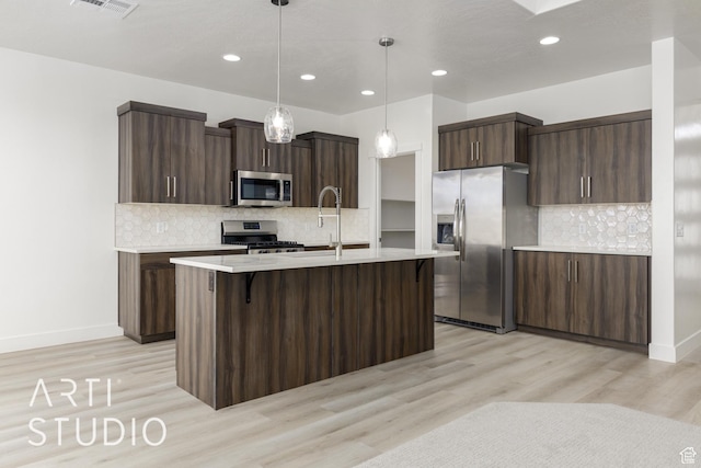 3551 E 3050th St S, St George, UT 84790 - kitchen with stainless steel appliances, light countertops, light wood-style floors, decorative backsplash, and recessed lighting
