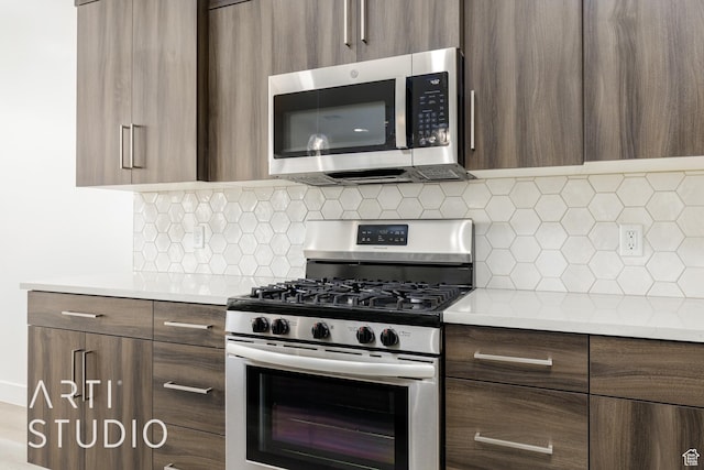 3551 E 3050th St S, St George, UT 84790 - kitchen with appliances with stainless steel finishes, modern cabinets, light countertops, and tasteful backsplash