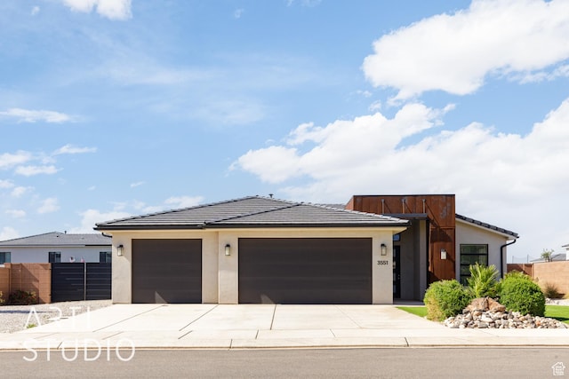 3551 E 3050th St S, St George, UT 84790 - view of front of house with concrete driveway, a garage, a tile roof, and stucco siding