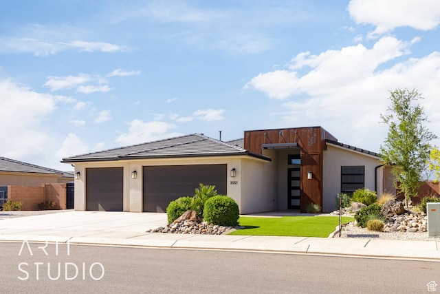 3551 E 3050th St S, St George, UT 84790 - modern home featuring stucco siding, driveway, an attached garage, and a tiled roof