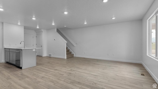 116 N Seaside St Unit 2317, Saratoga Springs, UT 84045 - unfurnished living room with a sink, recessed lighting, light wood-style floors, stairway, and baseboards