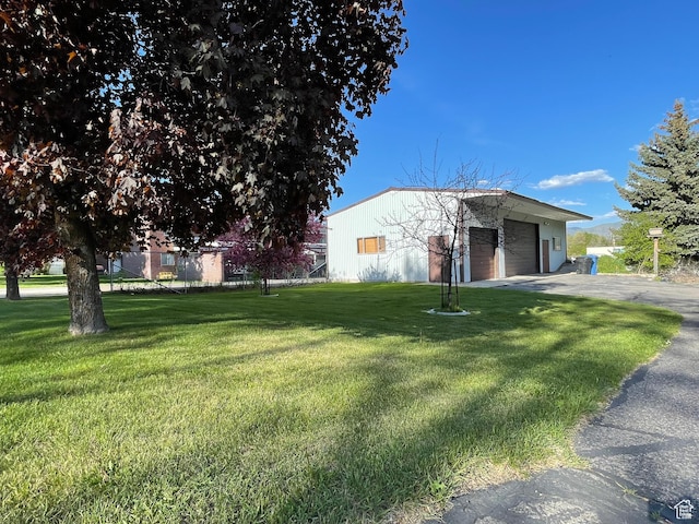 15 E Main, Wellsville, UT 84339 - view of front of home with a detached garage and a front yard
