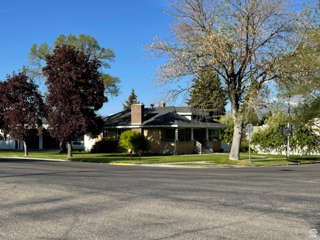 15 E Main, Wellsville, UT 84339 - view of front of house featuring a chimney and a front lawn