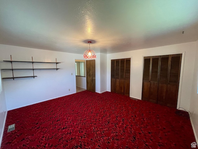 15 E Main, Wellsville, UT 84339 - unfurnished bedroom with multiple closets, carpet floors, and baseboards