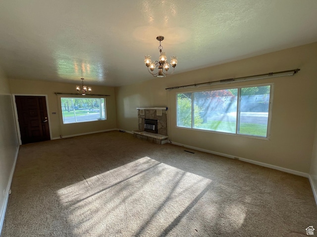 15 E Main, Wellsville, UT 84339 - unfurnished living room with a chandelier, carpet floors, baseboards, a fireplace, and a textured ceiling