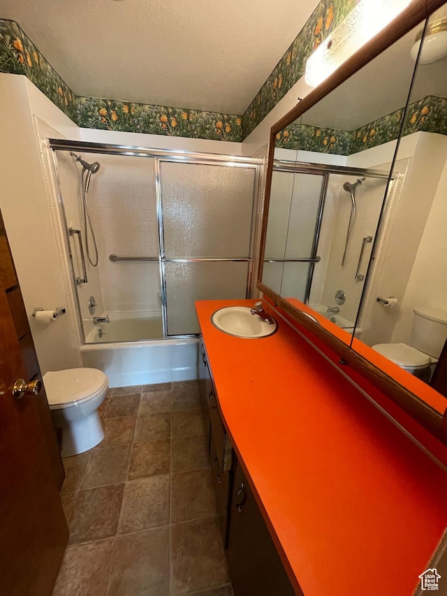 15 E Main, Wellsville, UT 84339 - bathroom with toilet, double vanity, bath / shower combo with glass door, and a textured ceiling