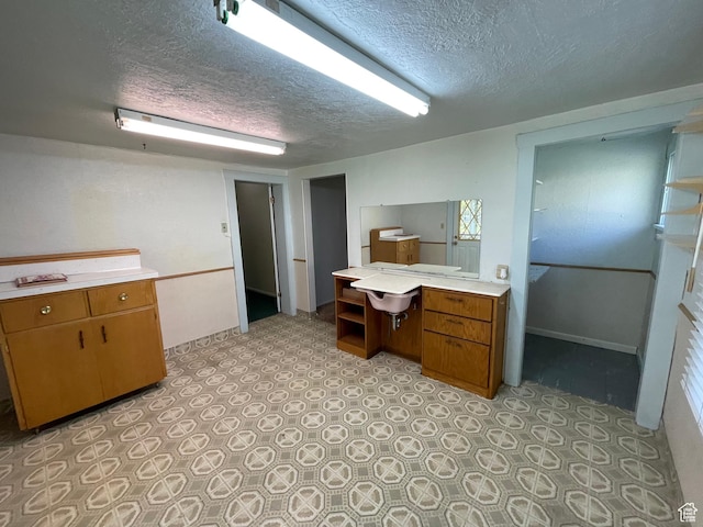 15 E Main, Wellsville, UT 84339 - kitchen with light countertops, a textured ceiling, and brown cabinets