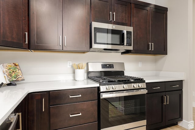 kitchen featuring appliances with stainless steel finishes, dark brown cabinets, and light countertops