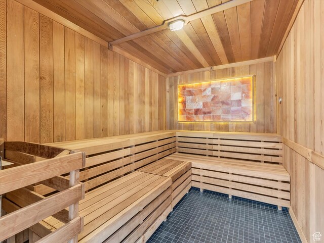 sauna / steam room featuring wood walls, wood ceiling, and tile patterned flooring