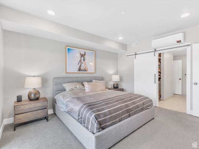 carpeted bedroom with a wall mounted AC, a barn door, recessed lighting, and baseboards