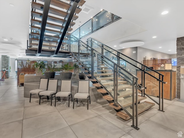 stairs with concrete floors and recessed lighting
