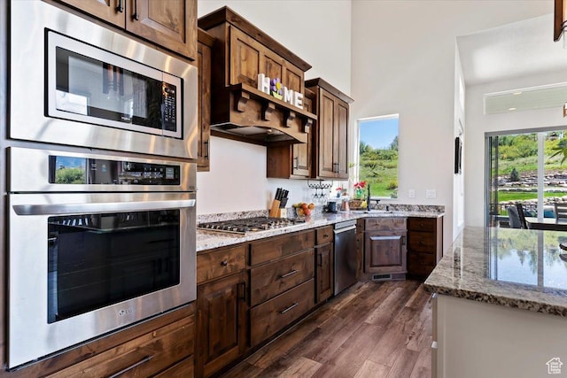 3416 W Spring Cir, Mountain Green, UT 84050 - kitchen with stainless steel appliances, light stone counters, dark wood-style floors, and dark brown cabinetry