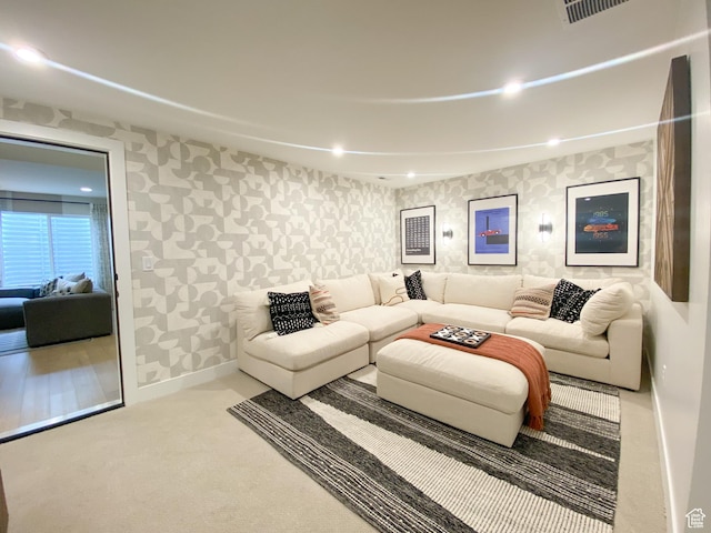carpeted living room featuring wallpapered walls, baseboards, and recessed lighting