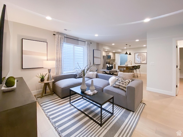 living room featuring baseboards and recessed lighting