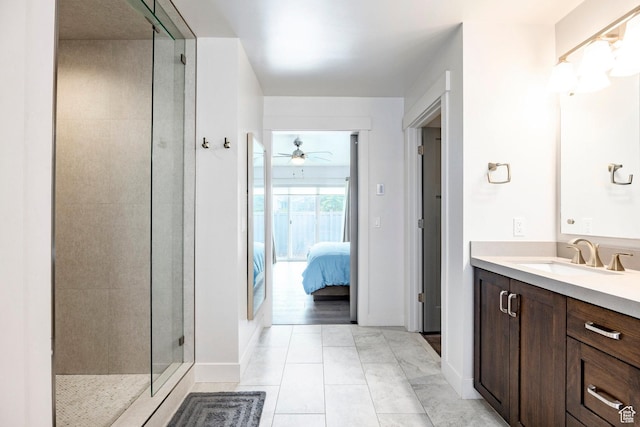 full bathroom with a stall shower, a ceiling fan, ensuite bathroom, vanity, and tile patterned floors