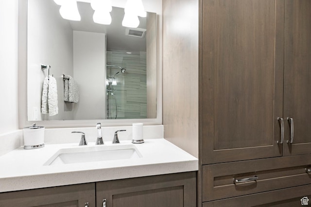 full bath featuring a shower and vanity