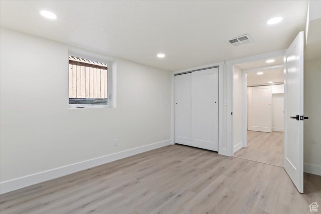 unfurnished bedroom with light wood finished floors, recessed lighting, baseboards, and a closet