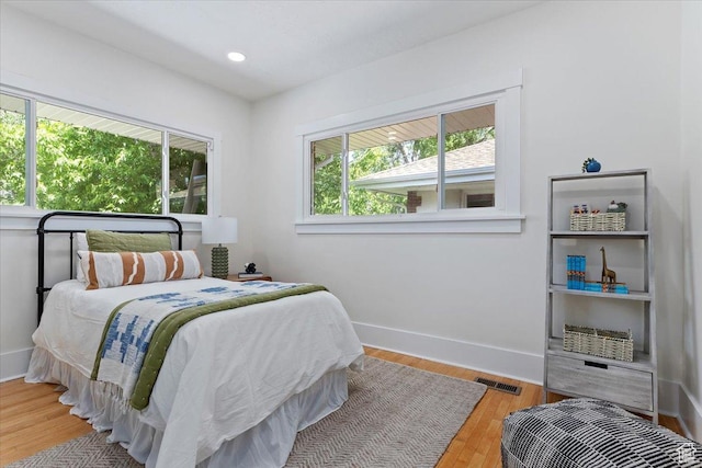bedroom with wood finished floors and baseboards