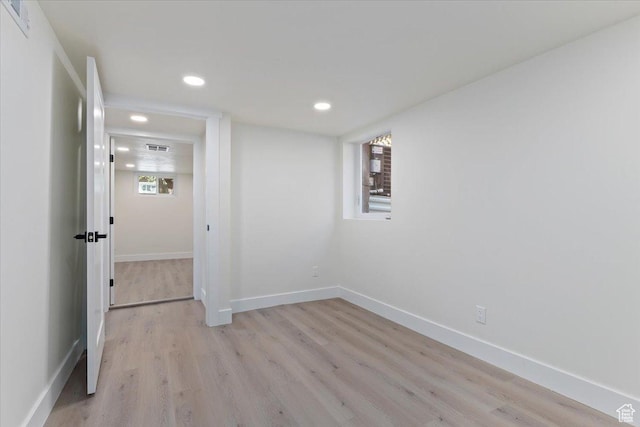 unfurnished room with recessed lighting, light wood-style floors, and baseboards